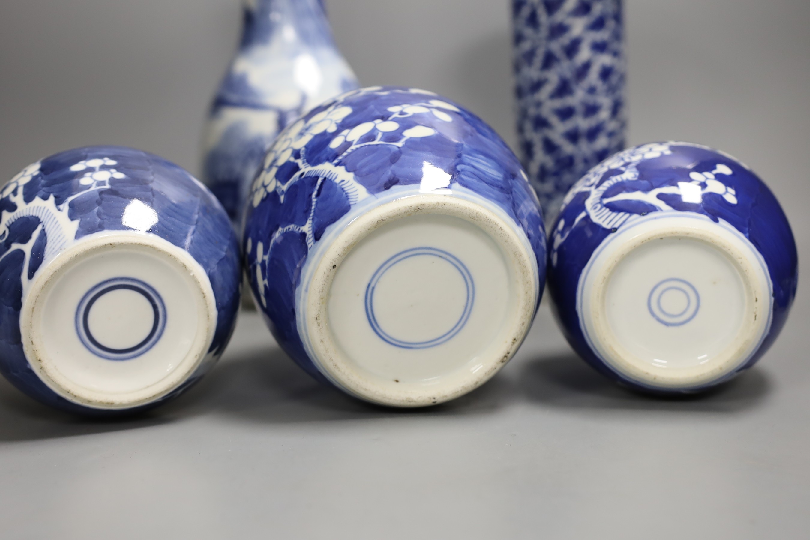 A 19th century Chinese blue and white ‘landscape’ vase, an early 20th century blue and white sleeve vase and three blue and white jars and covers. Tallest 25.5cm